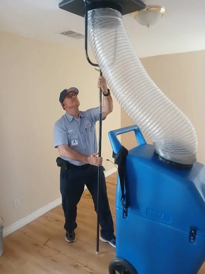 Furnace Tune-Up technician using HEPA equipment in Dallas